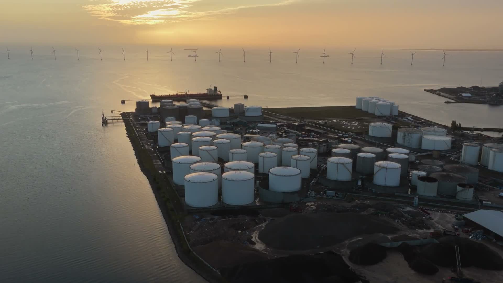 Industrial storage terminals and maritime infrastructure at sunset